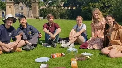 Members of the CU sat on the Trinity Lawns