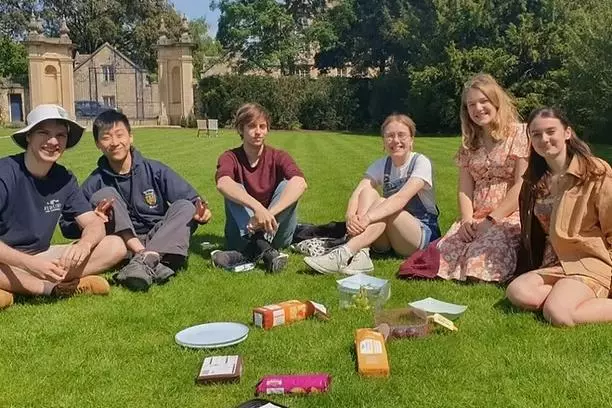 Members of the CU sat on the Trinity Lawns