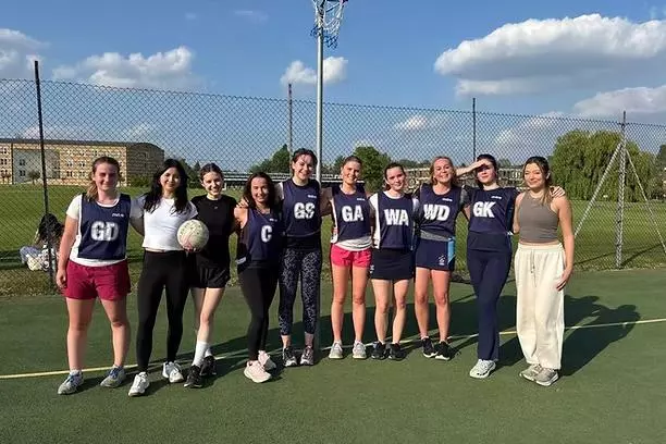 The Trinity College Netball team together on the pitch